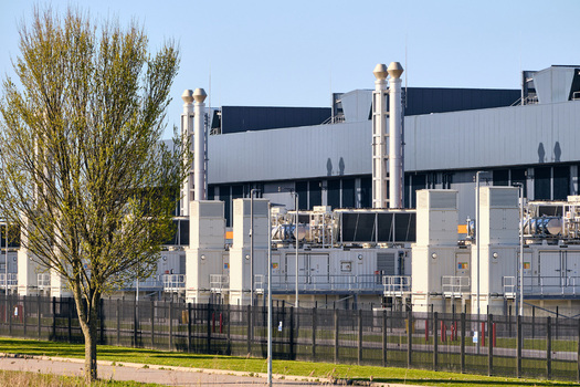 Middenmeer Netherlands 14 April 2026 View of the Microsoft datacenter AMS13 featuring large cooling units exhaust stacks and a security fence under a clear blue sky. Middenmeer Netherlands 14 April 2026 View of the Microsoft datacenter AMS13 featuring large cooling units exhaust stacks and a security fence under a clear blue sky.