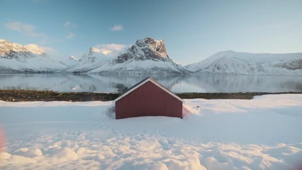 View of a red building and snowy mountains Norway.