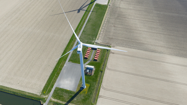 Aerial view of battery storage system at wind park with wind turbines