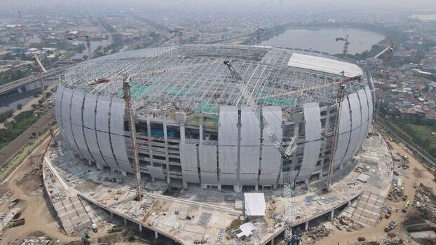 Aerial view of Jakarta International Stadium under construction with steel framework and surrounding cranes in Tanjung Priok Jakarta Indonesia. Aerial view of Jakarta International Stadium under construction with steel framework and surrounding cranes in Tanjung Priok Jakarta Indonesia.