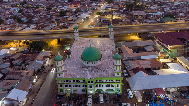 Aerial view of Tamale Central Mosque with its distinctive green dome and minarets surrounded by the urban landscape and roads of Tamale Northern Region Ghana. Aerial view of Tamale Central Mosque with its distinctive green dome and minarets surrounded by the urban landscape and roads of Tamale Northern Region Ghana.
