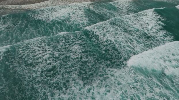 Aerial view of turquoise ocean waves breaking United States.