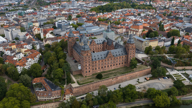 Aerial view of Schloss Johannisburg a historic Renaissance castle with red sandstone walls and a central courtyard situated near the Main river in Aschaffenburg Bayern Germany.