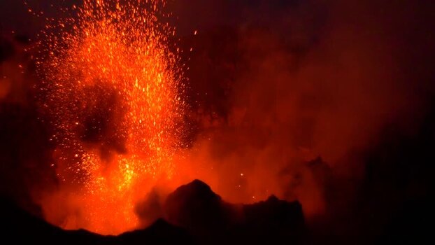 View of Stromboli volcano erupting at night Italy.