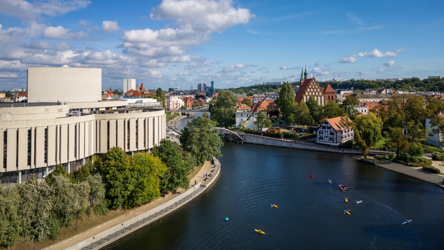 Aerial view of the Opera Nova s striking white facade contrasting with the deep blue Brda River while kayaks glide below the gothic cathedral Bydgoszcz Województwo kujawsko pomorskie Poland. Aerial view of the Opera Nova s striking white facade contrasting with the deep blue Brda River while kayaks glide below the gothic cathedral Bydgoszcz Województwo kujawsko pomorskie Poland.