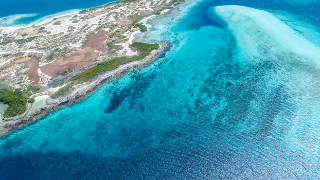 Aerial view of Los Roques archipelago featuring turquoise waters coral reefs and sandy islands in Los Roques Dependencias Federales Venezuela. Aerial view of Los Roques archipelago featuring turquoise waters coral reefs and sandy islands in Los Roques Dependencias Federales Venezuela.
