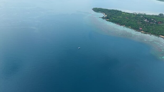 Aerial view of island with lush trees Indonesia. Aerial view of island with lush trees Indonesia.