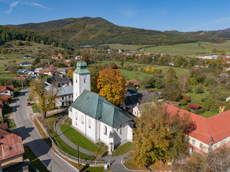 Aerial view of the white church with green roof nestled among vivid autumn trees and distant green mountains Klastor pod Znievom Zilina Region Slovakia. Aerial view of the white church with green roof nestled among vivid autumn trees and distant green mountains Klastor pod Znievom Zilina Region Slovakia.