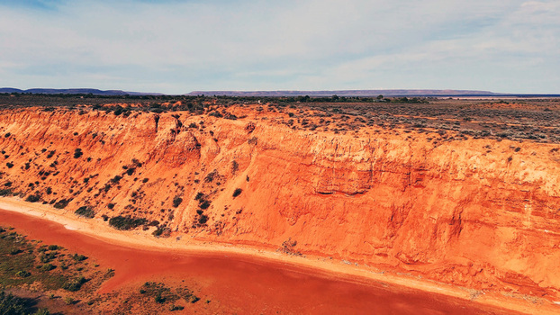 Aerial view of Matthew Flinders Red Cliff Lookout featuring red sandstone cliffs overlooking the arid landscape in Port Augusta West South Australia Australia. Aerial view of Matthew Flinders Red Cliff Lookout featuring red sandstone cliffs overlooking the arid landscape in Port Augusta West South Australia Australia.
