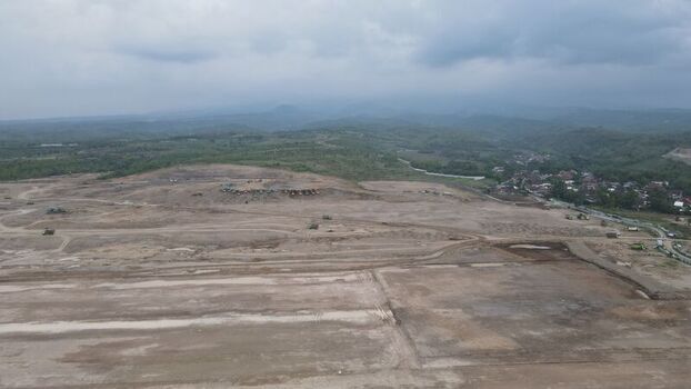 Aerial view of the Dhoho International Airport construction site showing vast cleared land heavy machinery and surrounding hills in Kecamatan Grogol Jawa Timur Indonesia. Aerial view of the Dhoho International Airport construction site showing vast cleared land heavy machinery and surrounding hills in Kecamatan Grogol Jawa Timur Indonesia.