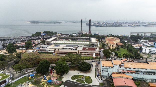 Aerial view of Onikan Stadium and the surrounding urban landscape of Lagos Island with the waterfront and bridge in the background Lagos Lagos Nigeria. Aerial view of Onikan Stadium and the surrounding urban landscape of Lagos Island with the waterfront and bridge in the background Lagos Lagos Nigeria.