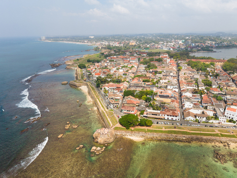 Aerial view of the historic Galle Fort with stone walls red tiled rooftops and turquoise ocean waves Galle Southern Province Sri Lanka. Aerial view of the historic Galle Fort with stone walls red tiled rooftops and turquoise ocean waves Galle Southern Province Sri Lanka.