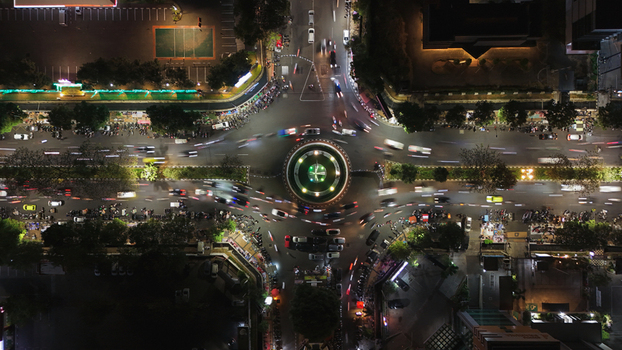 Aerial view of the Simpang Lima roundabout at night with illuminated traffic light trails surrounding urban buildings and street lights in Semarang Central Java Indonesia. Aerial view of the Simpang Lima roundabout at night with illuminated traffic light trails surrounding urban buildings and street lights in Semarang Central Java Indonesia.