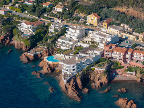 Aerial view of the coastal area of Le Trayas featuring white villas a swimming pool and rocky cliffs overlooking the Mediterranean Sea Saint Raphael Provence Alpes Cote d Azur France. Aerial view of the coastal area of Le Trayas featuring white villas a swimming pool and rocky cliffs overlooking the Mediterranean Sea Saint Raphael Provence Alpes Cote d Azur France.