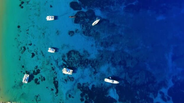Aerial view of boats in turquoise water Greece. Aerial view of boats in turquoise water Greece.