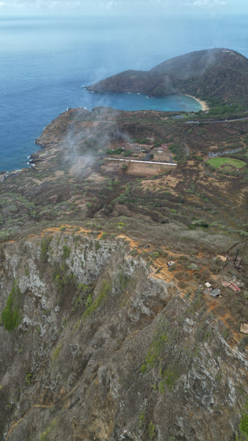 Aerial view of Koko Head volcano s rugged terrain meets the turquoise sea a stark contrast of scorched earth and vibrant ocean Honolulu Hawaii United States. Aerial view of Koko Head volcano s rugged terrain meets the turquoise sea a stark contrast of scorched earth and vibrant ocean Honolulu Hawaii United States.