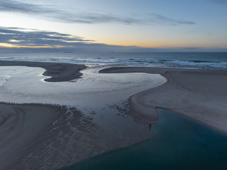 Aerial view of Lagoa de Obidos meeting the Atlantic Ocean at sunset with sandy banks and calm waters in Foz do Arelho Leiria District Portugal. Aerial view of Lagoa de Obidos meeting the Atlantic Ocean at sunset with sandy banks and calm waters in Foz do Arelho Leiria District Portugal.