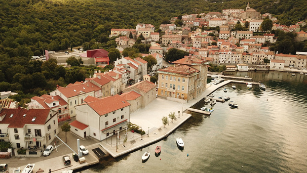 Aerial view of the coastal town with red roofed buildings a harbor and small boats moored along the waterfront in Bakarac Primorje Gorski Kotar Croatia. Aerial view of the coastal town with red roofed buildings a harbor and small boats moored along the waterfront in Bakarac Primorje Gorski Kotar Croatia.