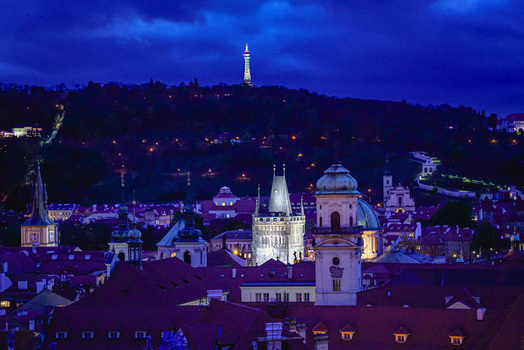 Aerial view of the illuminated Petrin Tower and historic rooftops of the old town at night in Prague Prague Czechia. Aerial view of the illuminated Petrin Tower and historic rooftops of the old town at night in Prague Prague Czechia.