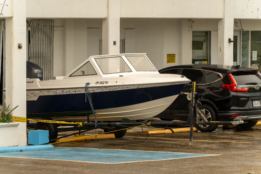 San Jose Tinian Northern Mariana Islands 05 July 2026 View of a motorboat on a trailer parked in front of a building in San Jose. San Jose Tinian Northern Mariana Islands 05 July 2026 View of a motorboat on a trailer parked in front of a building in San Jose.