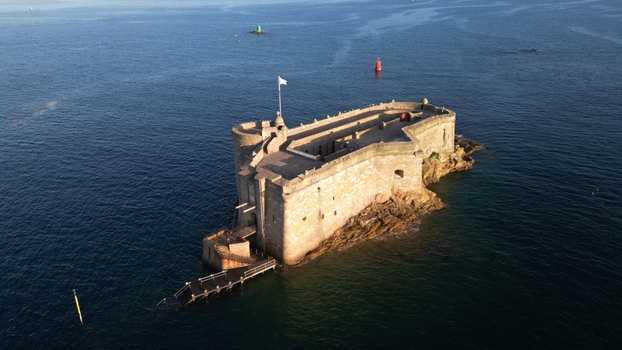 Aerial view of the historic Chateau du Taureau fortress its weathered stone walls rising stoically from the deep blue sea Plouezoc h Bretagne France. Aerial view of the historic Chateau du Taureau fortress its weathered stone walls rising stoically from the deep blue sea Plouezoc h Bretagne France.