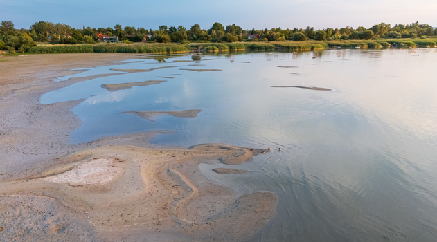 Aerial view of drought hit Lake Balaton shore with reeds and piers in summer Aerial view of drought hit Lake Balaton shore with reeds and piers in summer