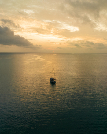 Aerial view of a solitary oil rig standing tall amidst the tranquil dark ocean under a muted sky Pine Island L &Icirc;le des Pins New Caledonia.