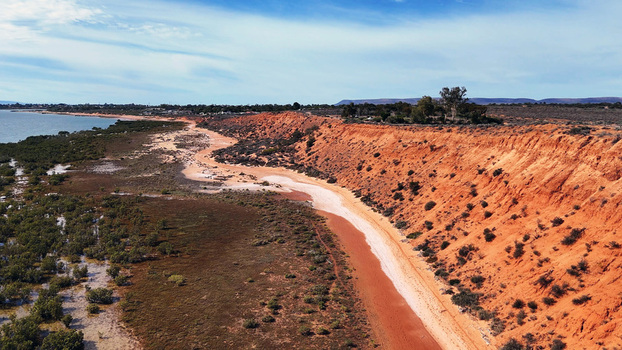 Aerial view of Matthew Flinders Red Cliff Lookout featuring red sandstone cliffs overlooking the Spencer Gulf with coastal vegetation Port Augusta West South Australia Australia. Aerial view of Matthew Flinders Red Cliff Lookout featuring red sandstone cliffs overlooking the Spencer Gulf with coastal vegetation Port Augusta West South Australia Australia.