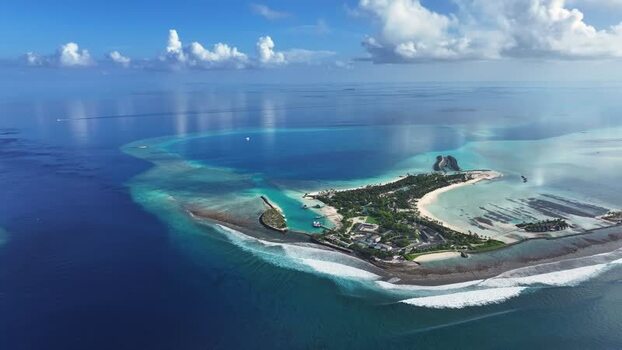 Aerial view of Thulusdhoo island and coral reefs Maldives.