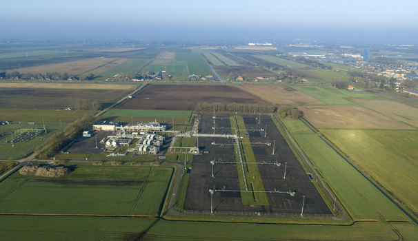Aerial view of the natural gas mining facility with industrial infrastructure and pipelines surrounded by agricultural fields in Slochteren Groningen Netherlands. Aerial view of the natural gas mining facility with industrial infrastructure and pipelines surrounded by agricultural fields in Slochteren Groningen Netherlands.