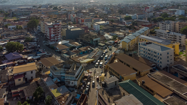 Aerial view of Accra Technical University surrounded by dense urban buildings busy streets with vehicles and rooftops under a clear sky in Accra Greater Accra Region Ghana. Aerial view of Accra Technical University surrounded by dense urban buildings busy streets with vehicles and rooftops under a clear sky in Accra Greater Accra Region Ghana.