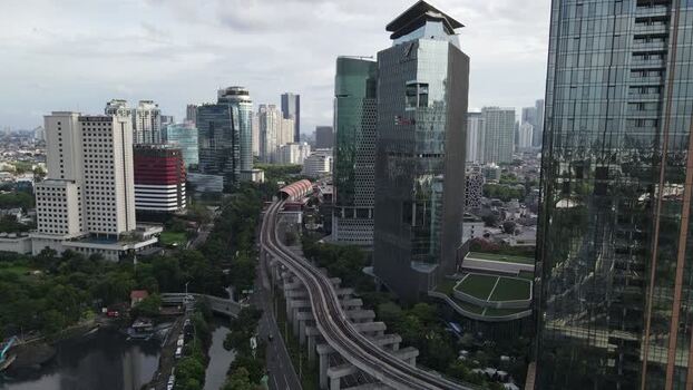 Aerial view of modern skyscrapers and the LRT track Indonesia. Aerial view of modern skyscrapers and the LRT track Indonesia.
