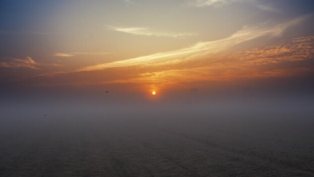 View of a foggy sunrise over rural fields in Bogura Bangladesh. View of a foggy sunrise over rural fields in Bogura Bangladesh.