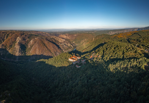 Aerial view of the Monastery of Santo Estevo de Ribas de Sil nestled in the lush forested hills of the Ribeira Sacra region in O Covelo Ourense Spain.