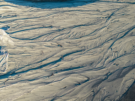 Aerial view of intricate sand patterns and water channels in a riverbed in Poland. Aerial view of intricate sand patterns and water channels in a riverbed in Poland.