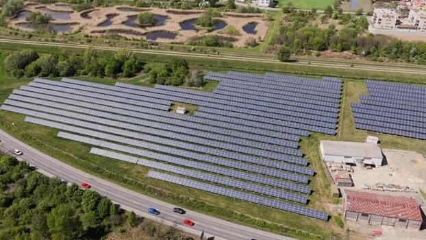 Aerial view of a large solar panel farm near a road Czechia. Aerial view of a large solar panel farm near a road Czechia.