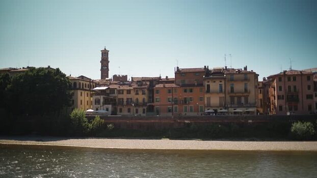 View of historic buildings and Lamberti Tower along the river Italy. View of historic buildings and Lamberti Tower along the river Italy.