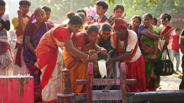 View of people performing a milk ritual during a festival Bangladesh View of people performing a milk ritual during a festival Bangladesh