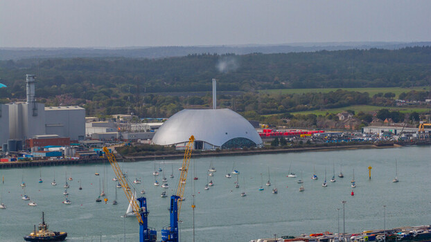 Aerial view of the Marchwood Energy Recovery Facility with its distinctive dome structure situated near the harbor with numerous boats and industrial cranes in Southampton England United Kingdom. Aerial view of the Marchwood Energy Recovery Facility with its distinctive dome structure situated near the harbor with numerous boats and industrial cranes in Southampton England United Kingdom.