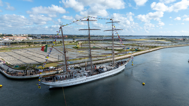 Aerial view of the tall ship NRP Sagres decorated with signal flags navigating the Canal de Aveiro near the salt pans Aveiro Aveiro Portugal. Aerial view of the tall ship NRP Sagres decorated with signal flags navigating the Canal de Aveiro near the salt pans Aveiro Aveiro Portugal.