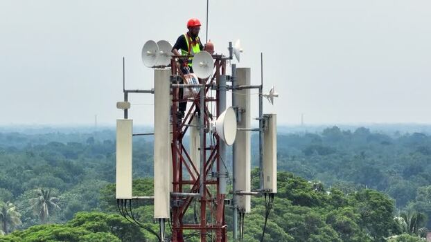 Aerial view of a technician working on a cell tower Bangladesh.
