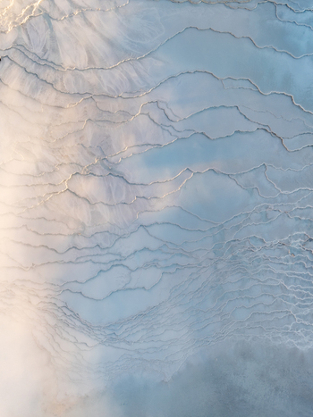 Aerial view of the geothermal landscape at Reykjanes featuring intricate mineral patterns and volcanic terrain in Grindavikurbaer Iceland. Aerial view of the geothermal landscape at Reykjanes featuring intricate mineral patterns and volcanic terrain in Grindavikurbaer Iceland.