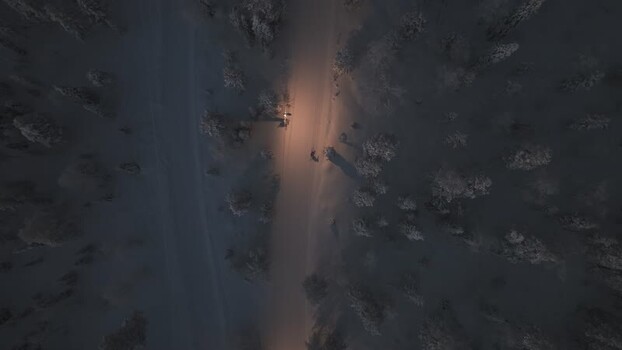 Aerial view of snowy forest road in Luosto Finland.