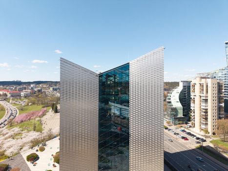 Aerial view of the modern glass facade of the Quadrum business center adjacent to the blooming cherry trees in Chiune Sugihara Sakura Park in Vilnius Vilniaus apskritis Lithuania. Aerial view of the modern glass facade of the Quadrum business center adjacent to the blooming cherry trees in Chiune Sugihara Sakura Park in Vilnius Vilniaus apskritis Lithuania.