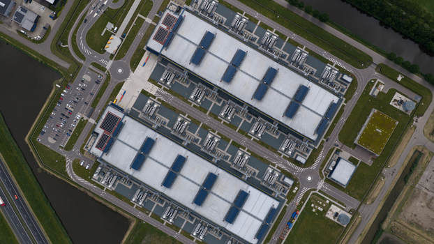 Aerial view of the Agriport industrial complex featuring large data center buildings with rooftop cooling systems and parking areas in Middenmeer Noord Holland Netherlands. Aerial view of the Agriport industrial complex featuring large data center buildings with rooftop cooling systems and parking areas in Middenmeer Noord Holland Netherlands.