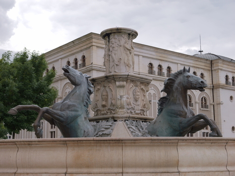 View of the bronze horse fountain with neoclassical architecture in the background in Skopje Greater Skopje North Macedonia.