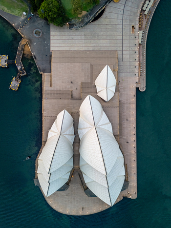 Aerial view of the iconic Sydney Opera House its white sails gleaming against the deep blue harbor waters a symphony of architectural brilliance Sydney New South Wales Australia. Aerial view of the iconic Sydney Opera House its white sails gleaming against the deep blue harbor waters a symphony of architectural brilliance Sydney New South Wales Australia.