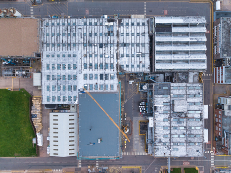 Aerial view of the industrial complex with its geometric rooftops and stark contrasts an urban landscape viewed from above Corby United Kingdom. Aerial view of the industrial complex with its geometric rooftops and stark contrasts an urban landscape viewed from above Corby United Kingdom.