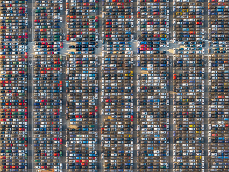 Aerial view of the automotive terminal at Civitavecchia Port filled with rows of parked new cars in Civitavecchia Lazio Italy. Aerial view of the automotive terminal at Civitavecchia Port filled with rows of parked new cars in Civitavecchia Lazio Italy.