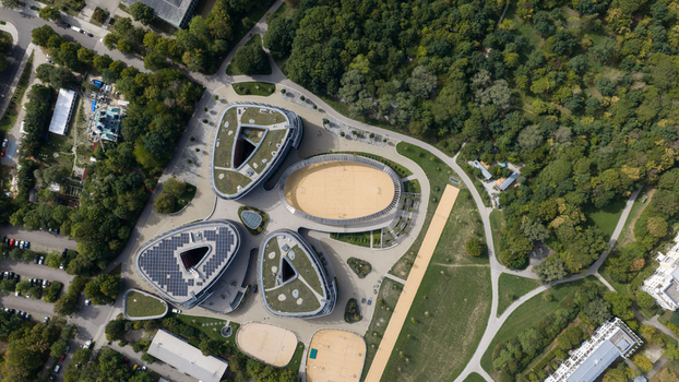 Durmersheim Germany 12 September 2026 Aerial view of Wilhelm Hausenstein Gymnasium with modern organic shaped buildings green roofs solar panels and sports courts set in a forest.